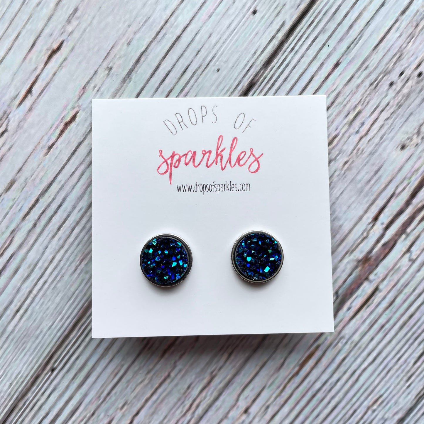 navy blue sparkly faux druzy stud earrings in silver settings.