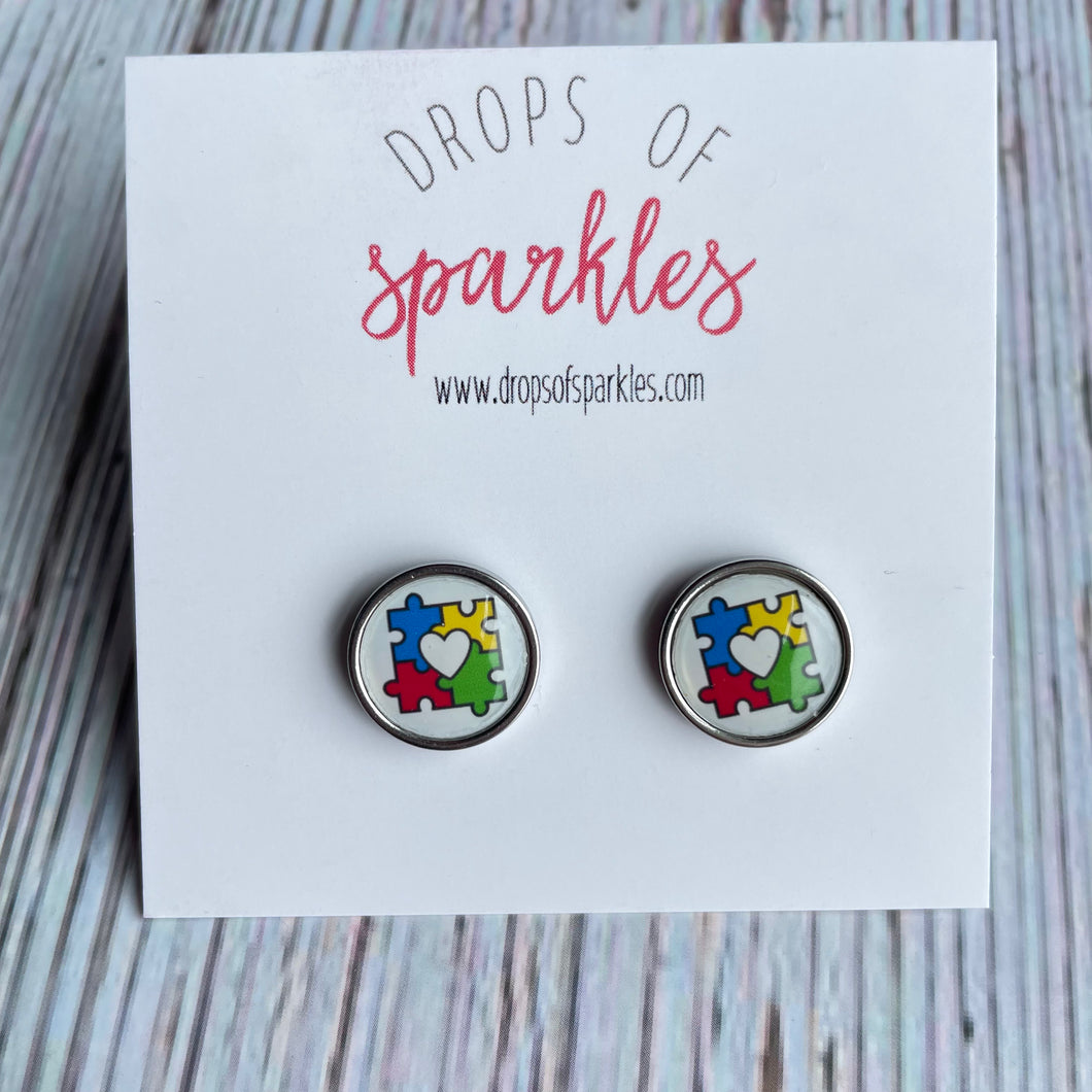 Colorful autism puzzle piece stud earrings.