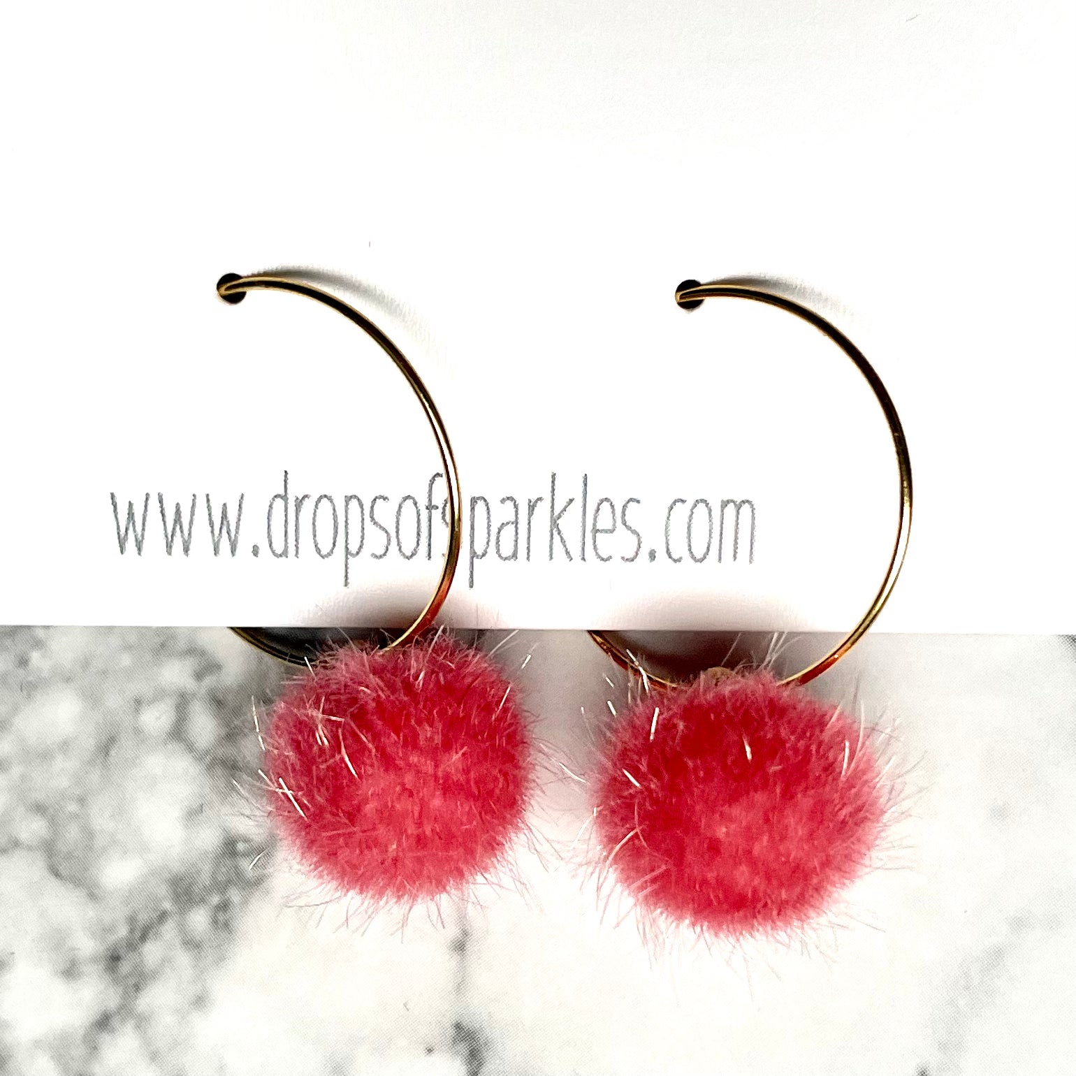 20mm round 24k shiny gold plated  "hoops" with fun little bubblegum pink fuzzy pom poms attached