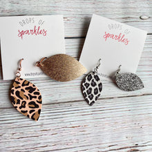 Load image into Gallery viewer, Thick faux leather almond shaped dangle earrings with coordinating shimmer on back sides.
