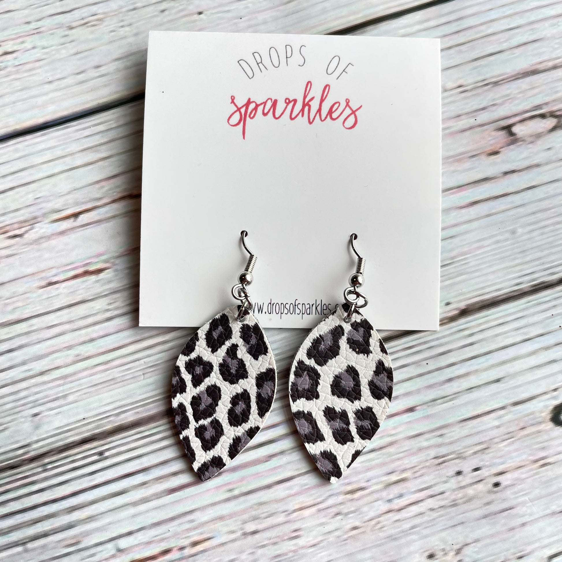 Thick white, gray and black faux leather almond shaped dangle earrings.