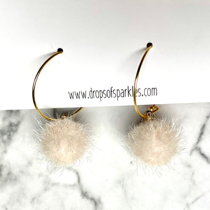 20mm round 24k shiny gold plated  "hoops" with fun little ivory fuzzy pom poms attached